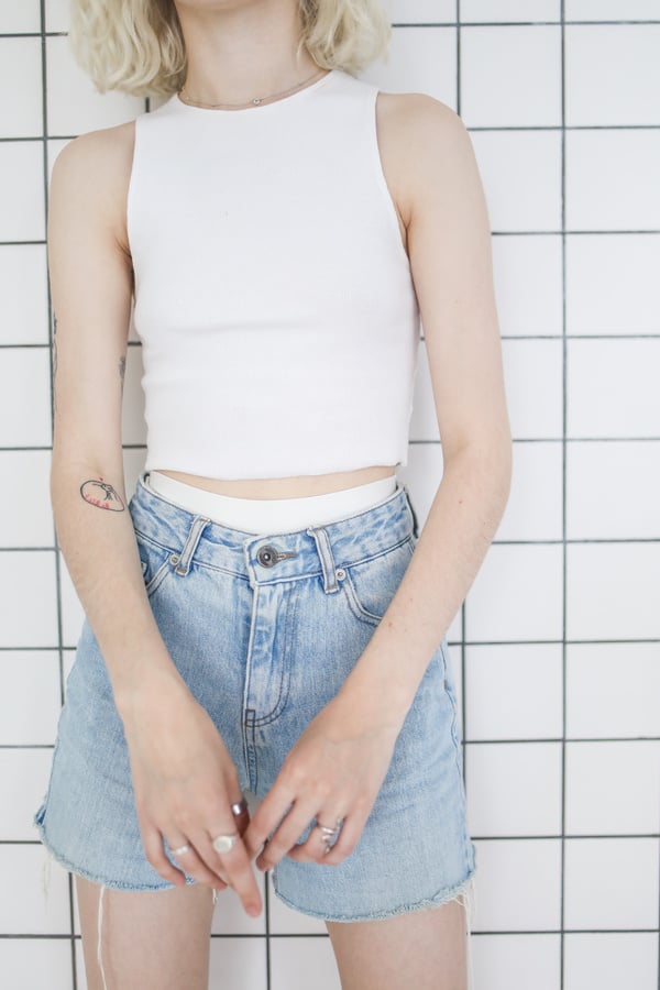 Girl in White Tank Top and Blue Denim Shorts